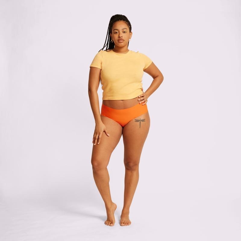 Model wearing orange hip huggers
