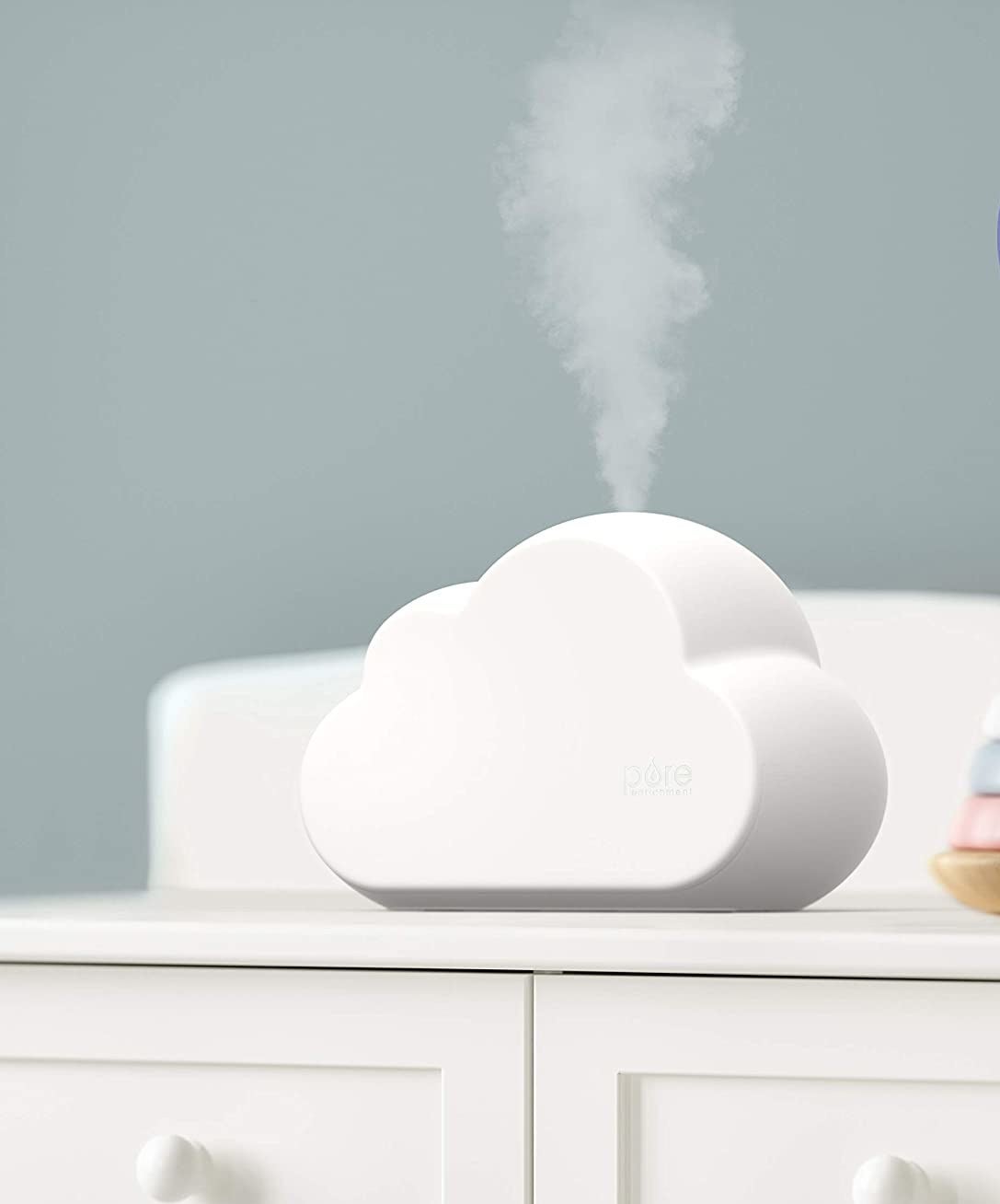 A cloud-shaped humidifier on a dresser 