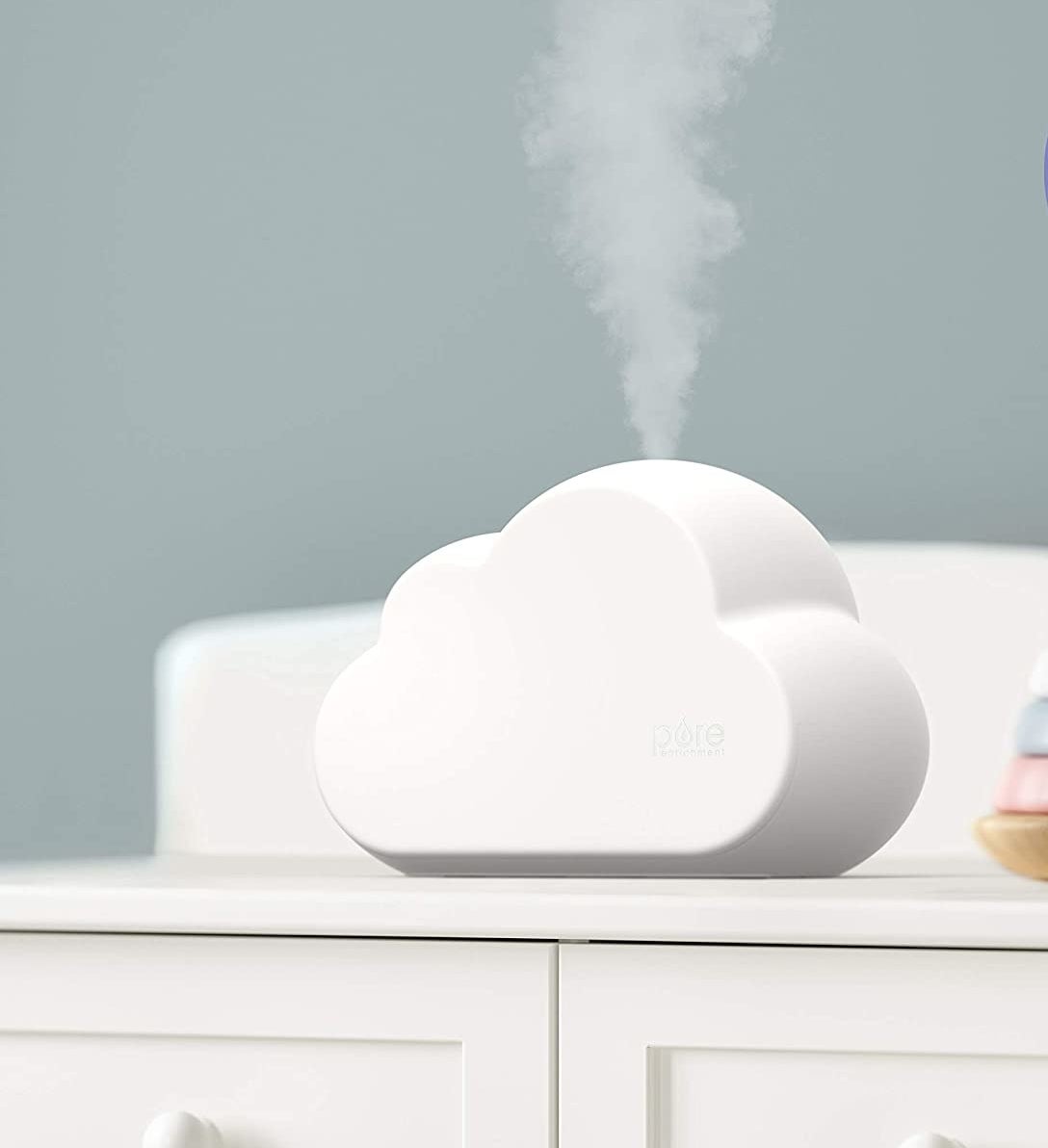 A cloud-shaped humidifier on a dresser 
