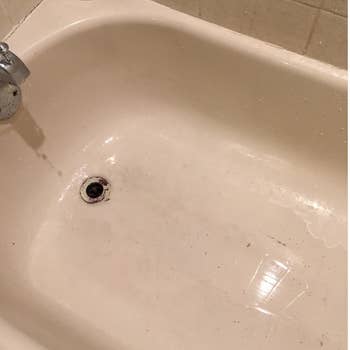 same tub with clean area near the drain after cleaned with rust stain remover