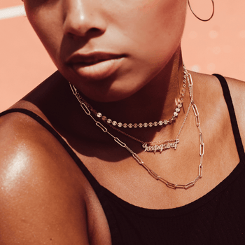 model wearing the necklace as a choker in gold