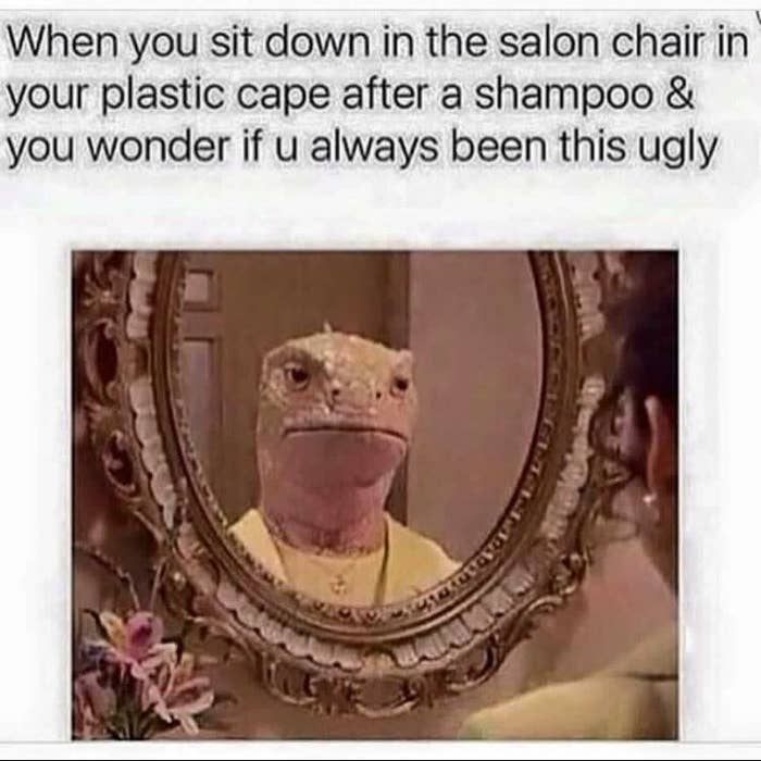 A woman sitting in front of a salon mirror and her reflection is reptile