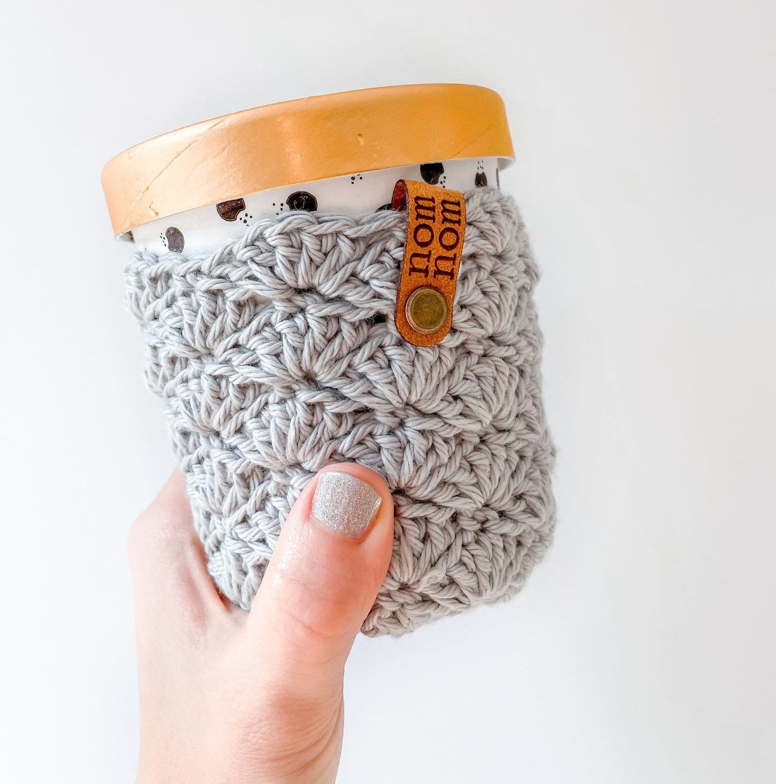 hand holding the crochet pint cover