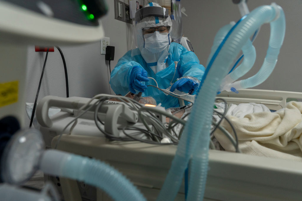 A medical staff putting a ventilator on a patient