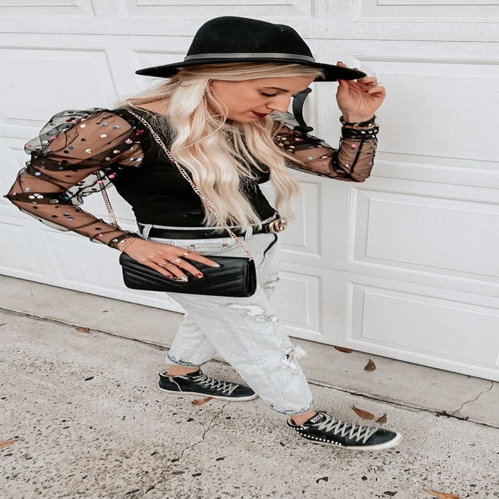 A reviewer wearing the top in polka dot