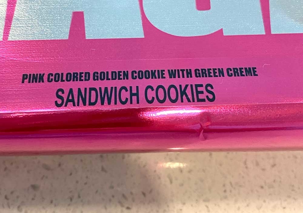 A close-up of the packaging saying, &quot;pink colored golden cookie with green creme&quot;