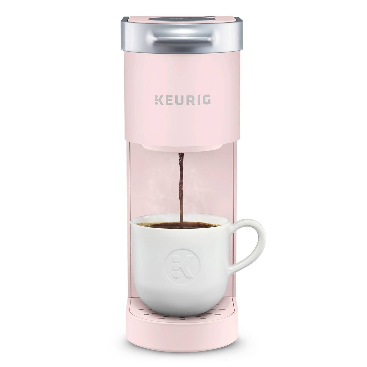 The coffee maker in light pink, which is narrow and has space for one coffee cup to be filled with coffee