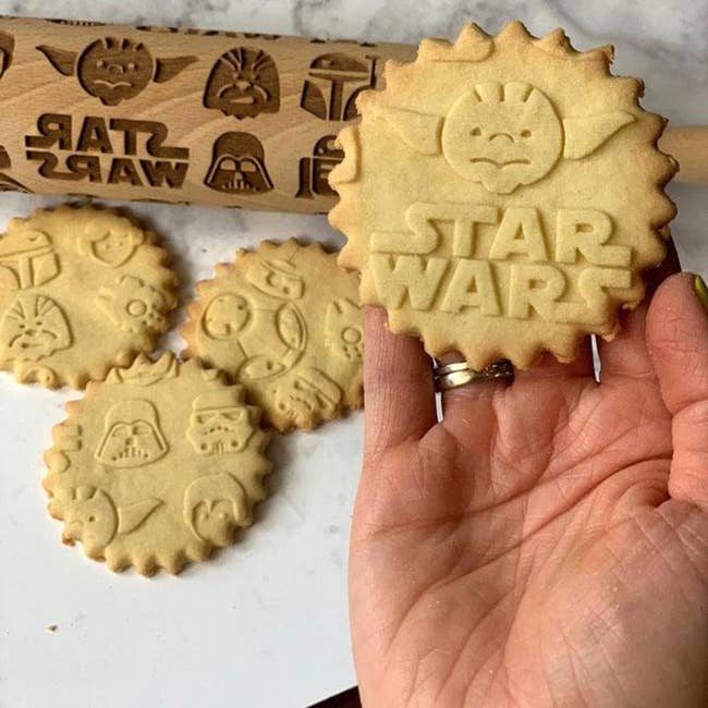 the star wars dough roller and cookies with various imprints on them made using the roller