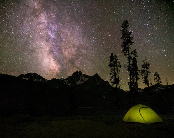 Gorgeous night sky and small, lit tent 