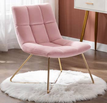 Pink accent chair over area rug