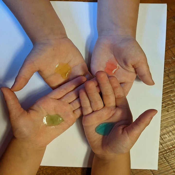 review photo of children's hands with different colored hand sanitizers 