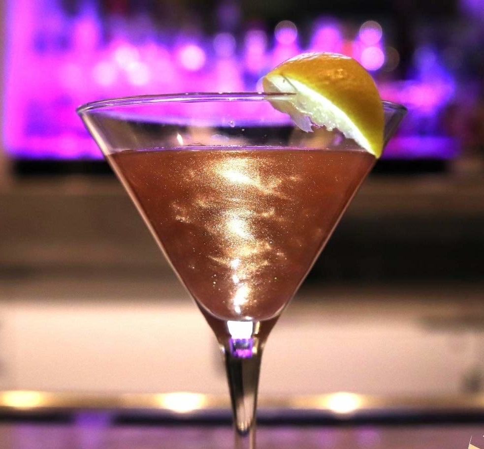 pearlescent pink drink in a martini glass