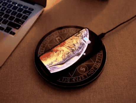 flat circular charger that lights up with runes when phone is on it 