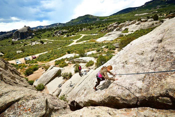Woman climbs large series of rocks in Idaho