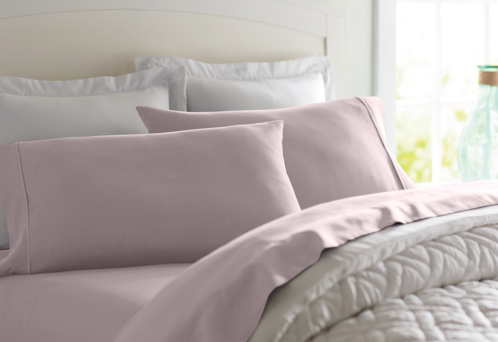 a bed made with the lavender microfiber sheets