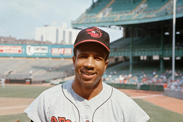 Frank Robinson in Orioles jersey and hat.