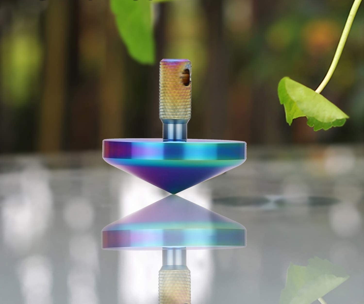 The spinning top on a reflective table 