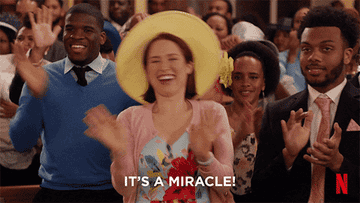 gif from the tv show unbreakable kimmy schmidt of kimmy in church waving her hands like she is praising and the caption reads it&#x27;s a miracle