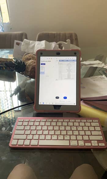reviewer using pink bluetooth keyboard with tablet