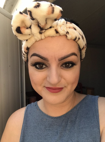 reviewer wears headband in leopard print