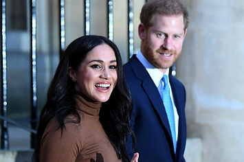 Meghan and Harry smile while on their way to an event