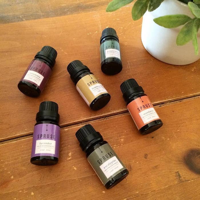 Six essential oils on a wooden countertop