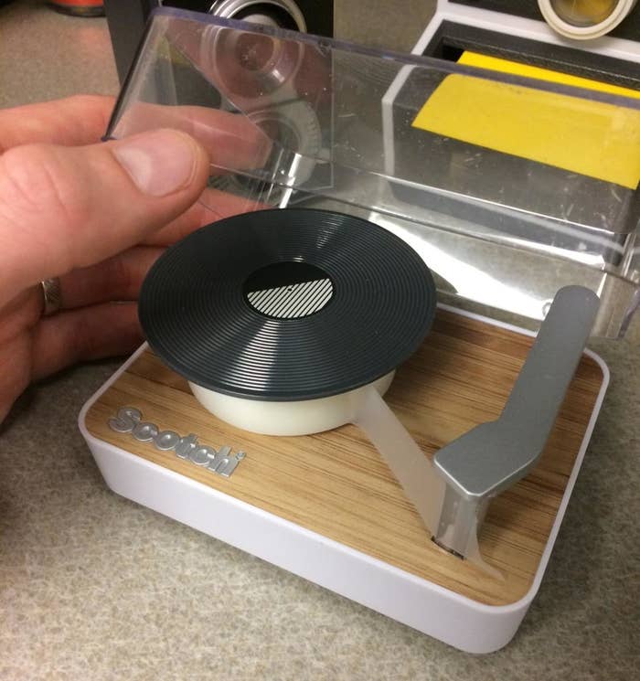 Reviewer holding top of tape case
