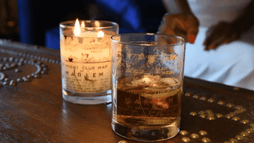 gif of candle lit beside a glass candle jar used for a cocktail glass
