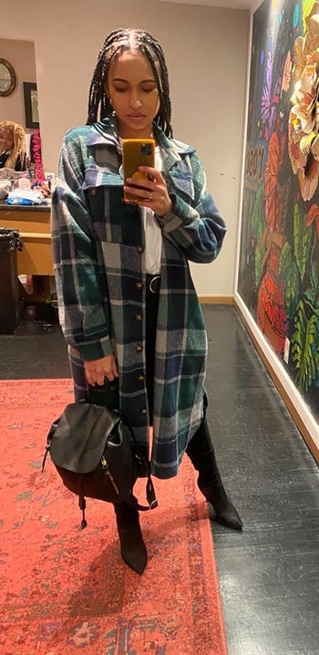 reviewer wearing the mid-calf length plaid jacket in blue and green