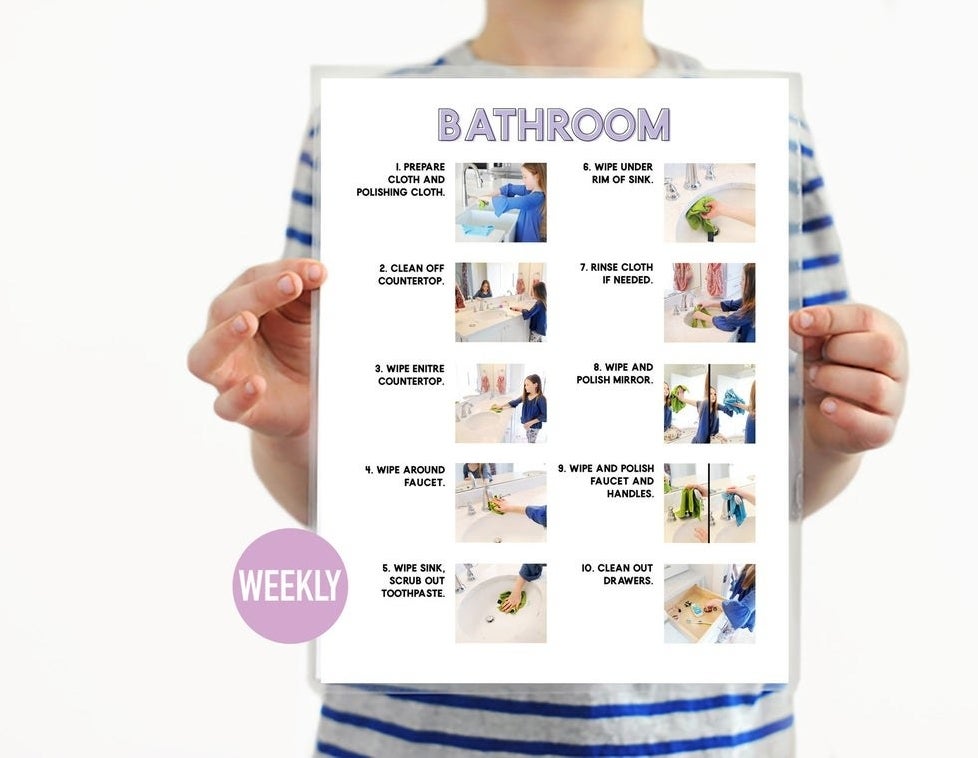 kid holding up the bathroom chore chart with directions and pictures 