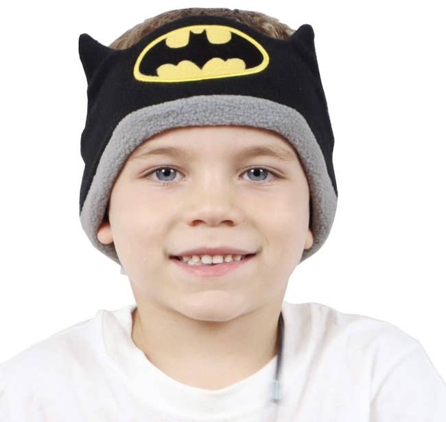 Child wearing Batman-themed headband earbuds 