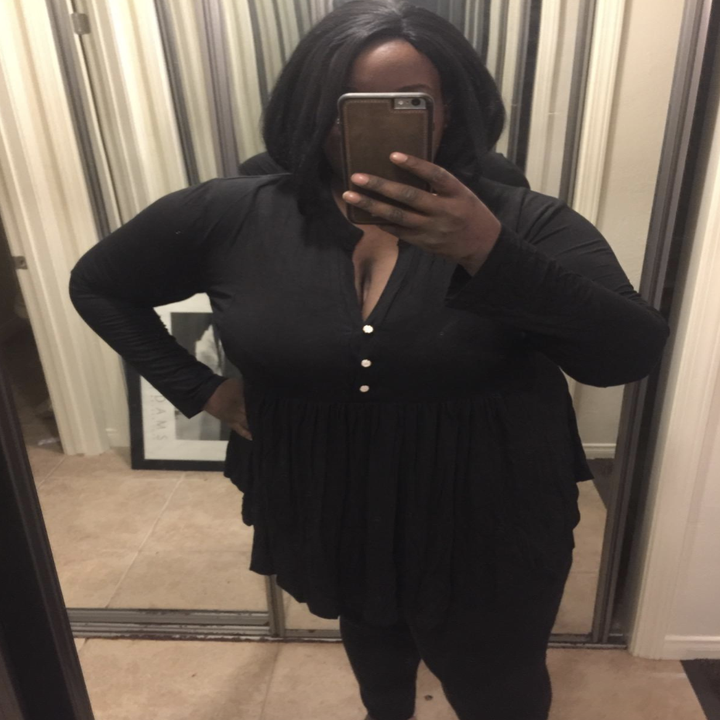 reviewer wearing the black V-neck button up top 