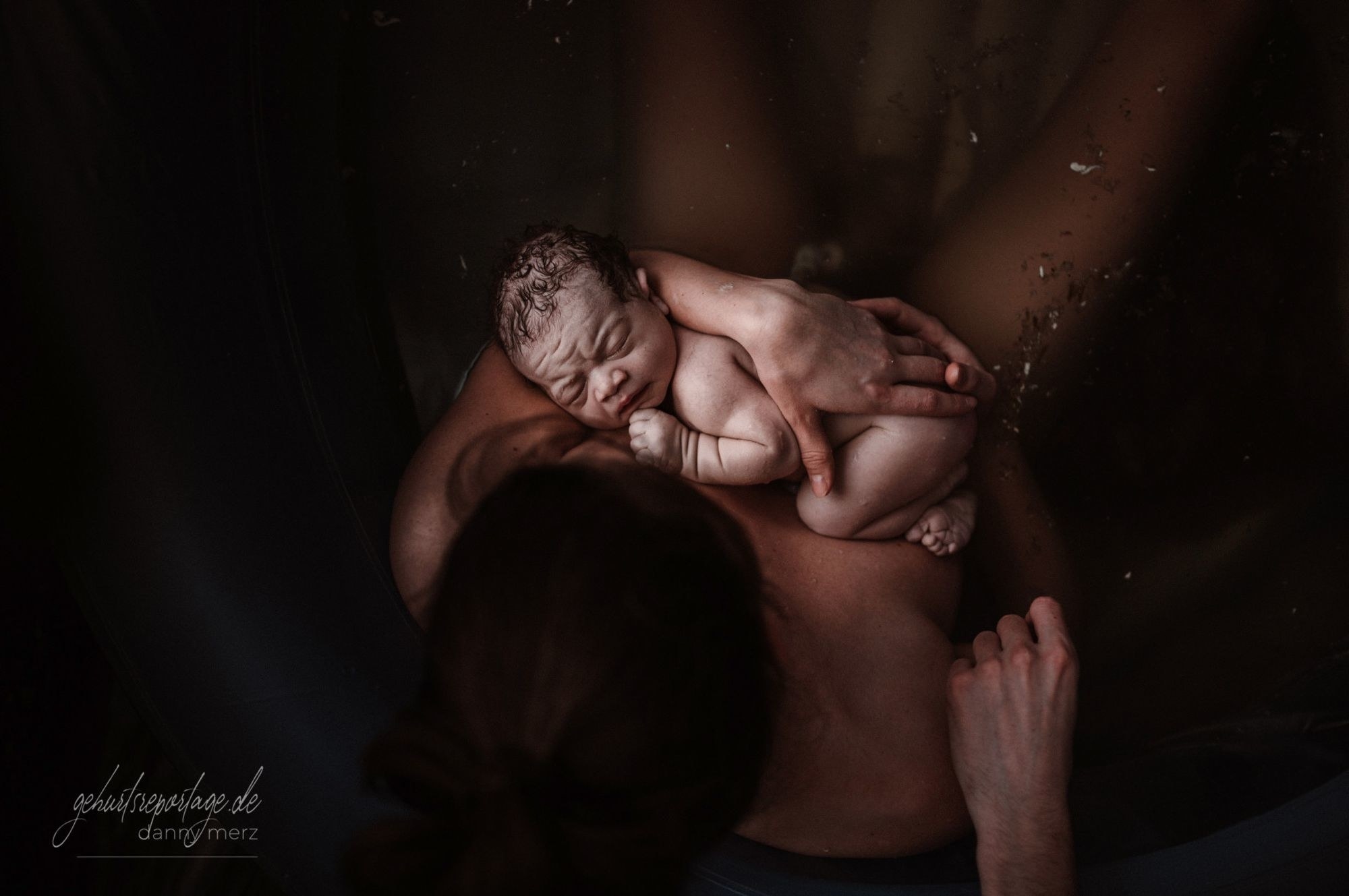 A newborn dozes on a naked mother&#x27;s chest