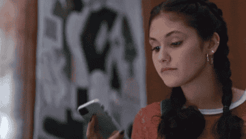 Olivia from &quot;On My Block&quot; looks surprised while reading something on her phone
