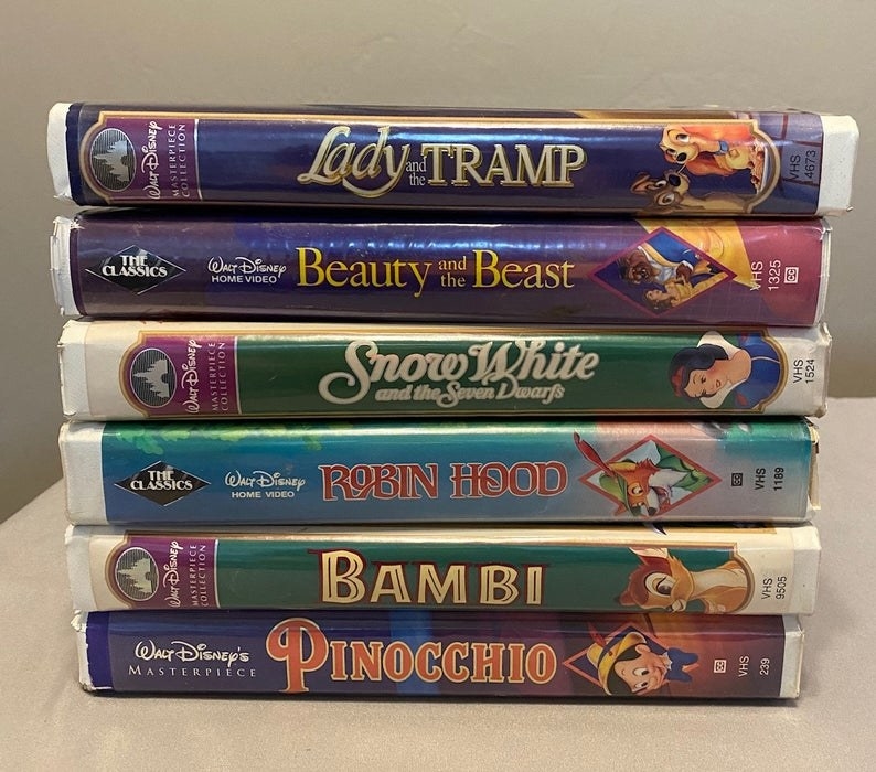 Six Disney clamshell VHS tapes stacked on each other