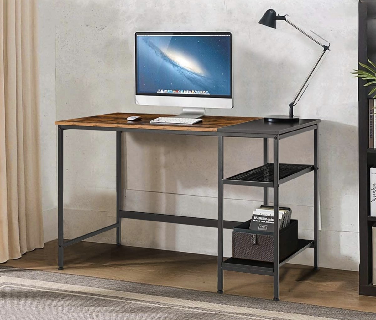 A gray metal and wood desk with open shelves on the right side