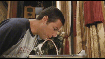 Adam Sandler drinking from a fruit punch fountain