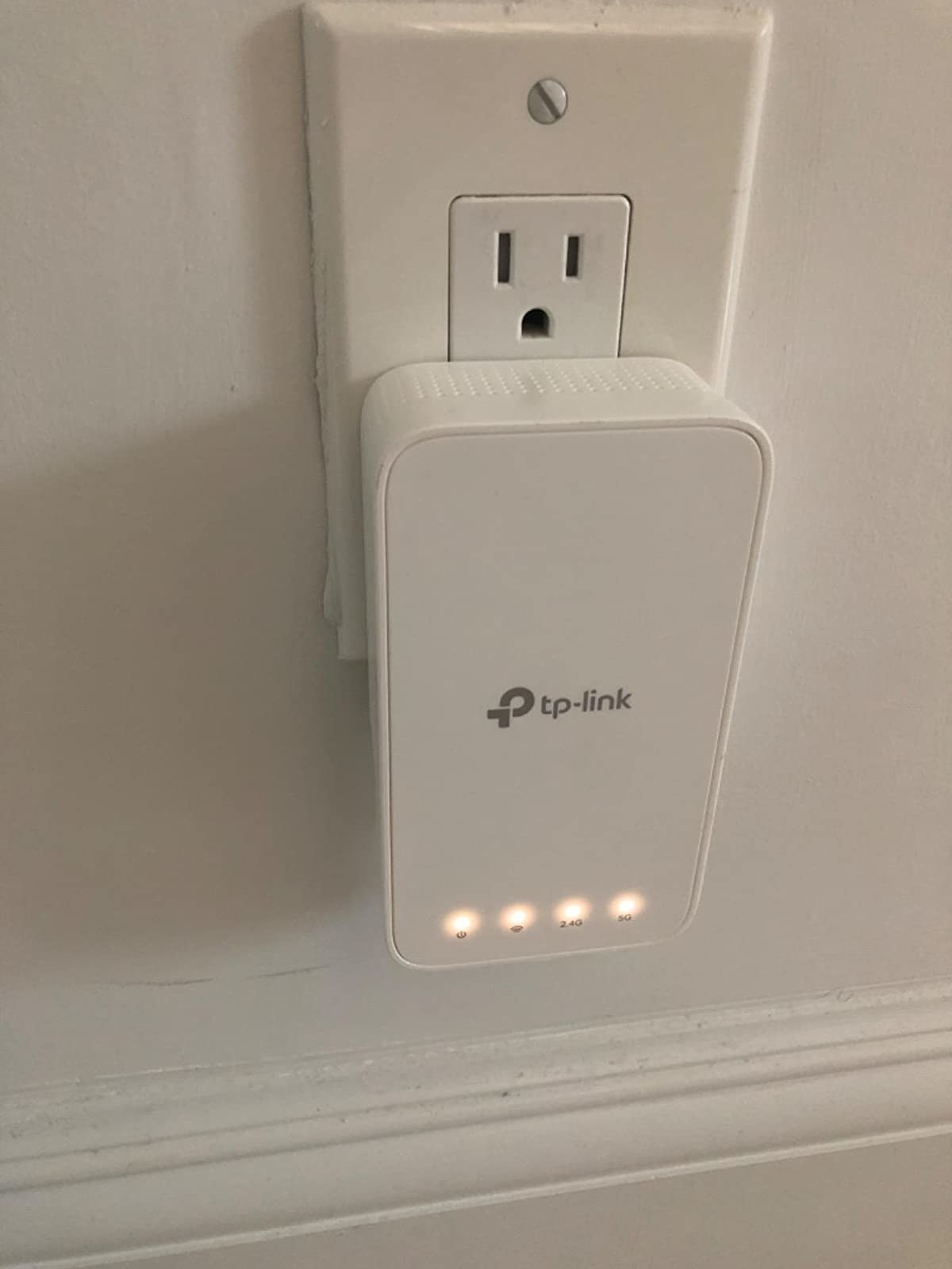 a reviewer&#x27;s wifi extender plugged into an outlet