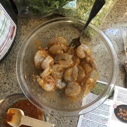 shrimp marinating in a honey harissa sauce mixture