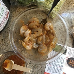 shrimp marinating in a honey harissa sauce mixture