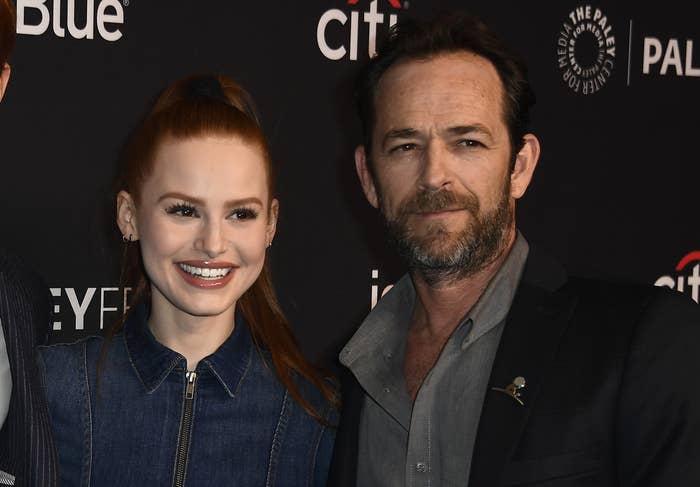 Luke and Madelaine pose together on a red carpet