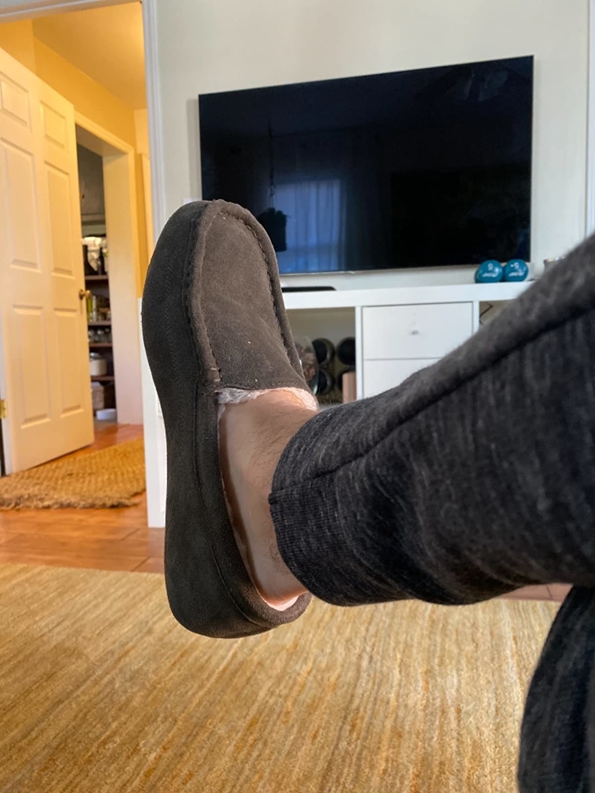Reviewer&#x27;s photo of their charcoal moccasin slippers
