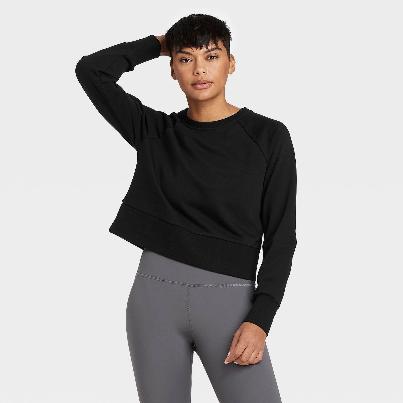 Model in black cropped sweatshirt