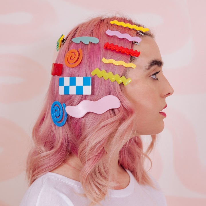 Model with pin hair wearing multiple fun and colorful hair grips