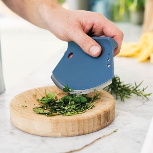 The herb chopper being used to dice up herbs