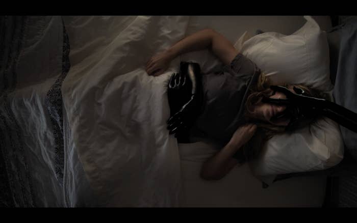 Madison Iseman as Rain Burroughs being consumed by gloved hands in &quot;Fear of Rain.&quot; 