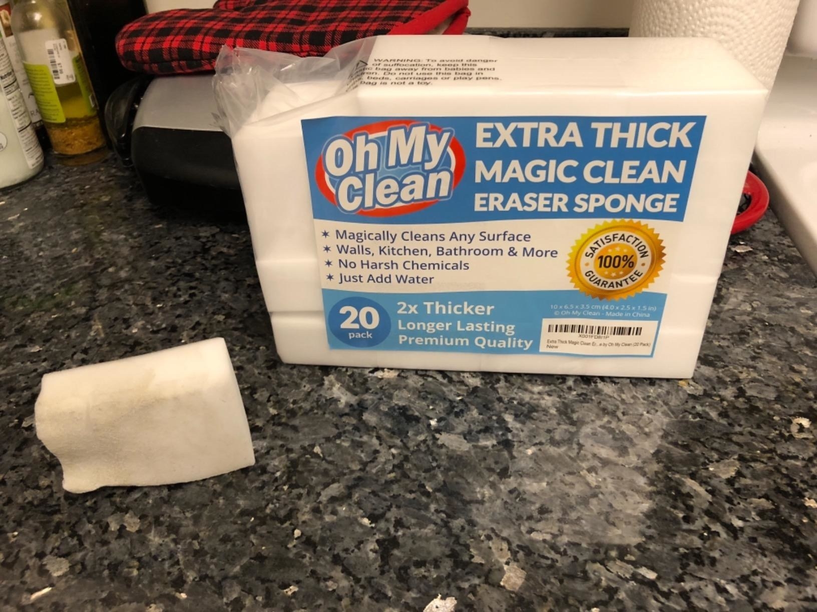 Reviewer photo of used cleaning sponge next to pack of 20