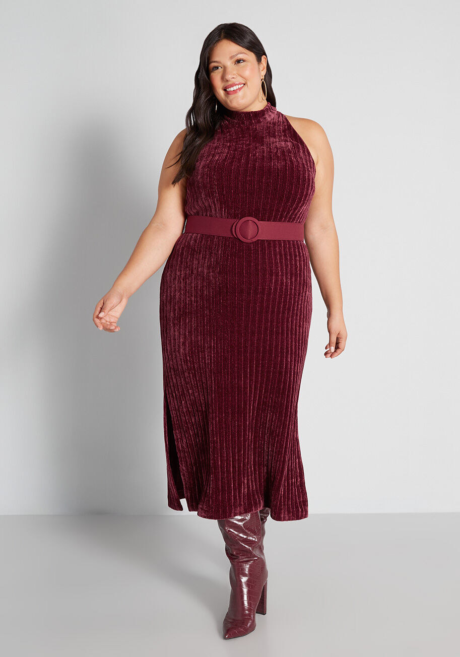 model in sleeveless merlot midi dress with thigh-high red boots