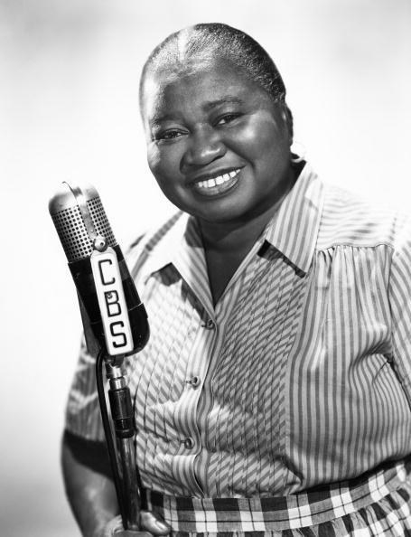 Hattie McDaniel sitting for a photo in front of the cbs microphone