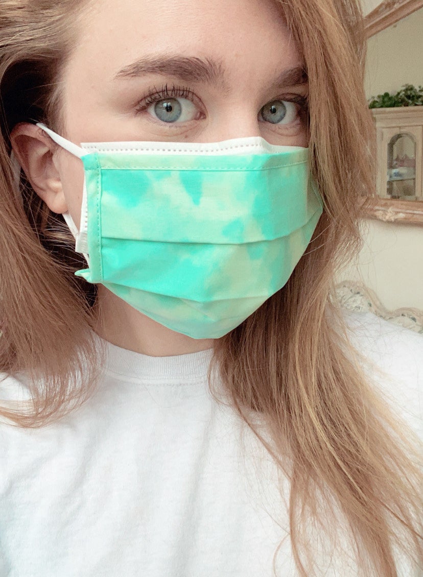 BuzzFeed editor with a reusable cloth face mask layered on top of a disposable face mask 